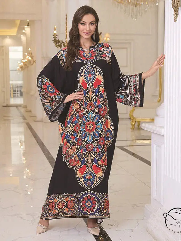 Elegant loose black kaftan dress with colorful floral pattern and bell sleeves