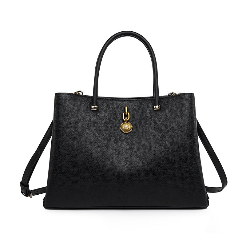 Black leather handbag with gold hardware and shoulder strap for luxury fashion ملابس