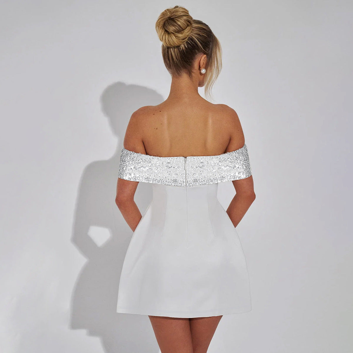 Elegant off-shoulder mini dress with lace trim, perfect for stylish fashion choices