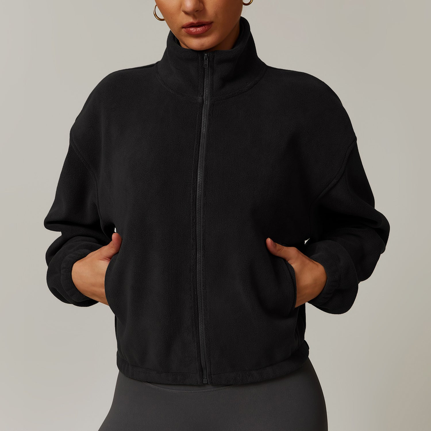 Black zip-up fleece jacket featuring a high collar and side pockets, ideal for Langry fashion
