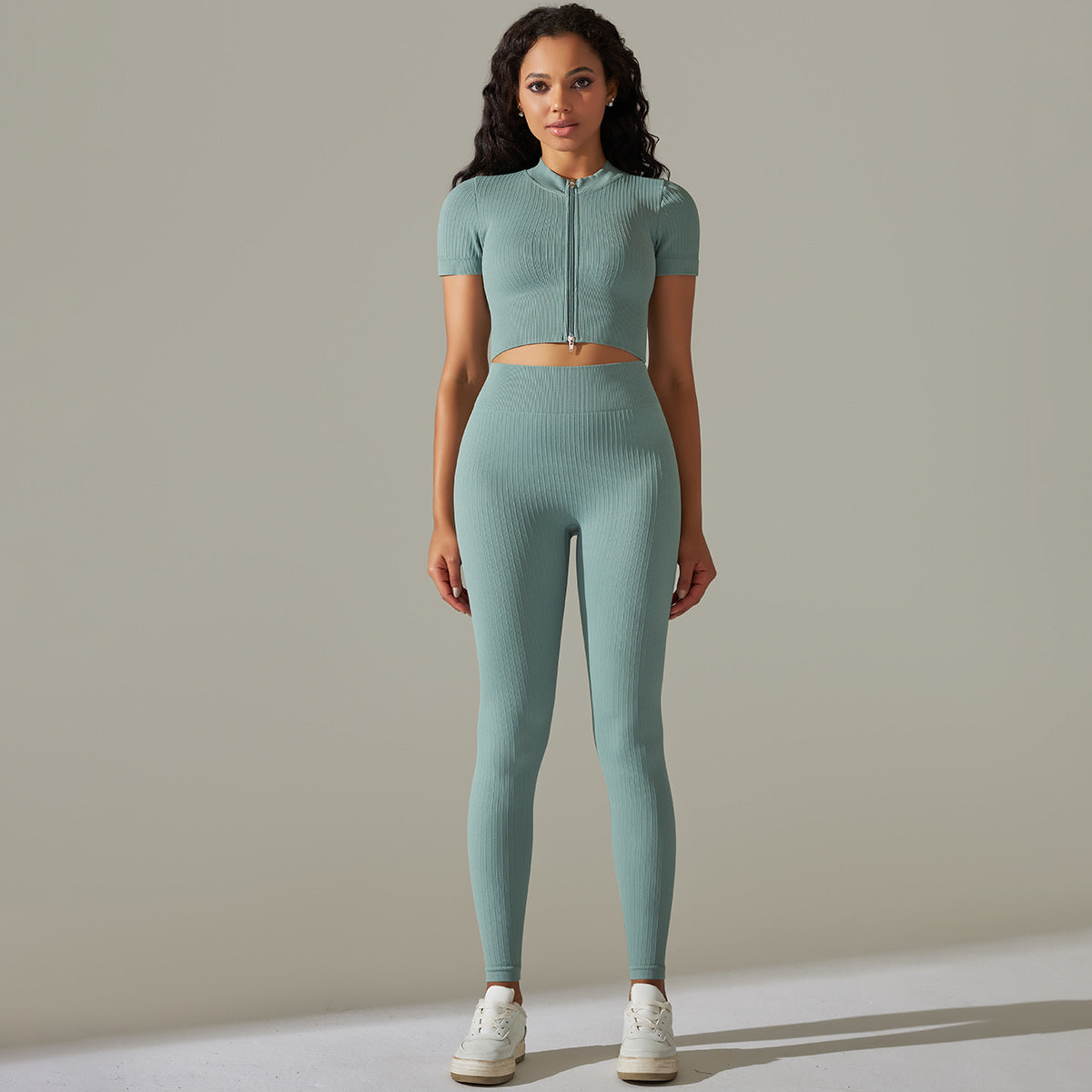 Woman in seamless knitted peach hip high waist yoga set wearing light-green athletic attire