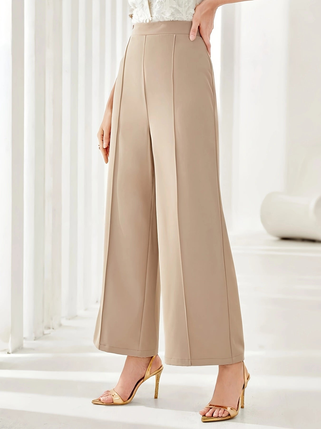Beige wide leg cropped dress pants styled with strappy tan heels for elegant fashion
