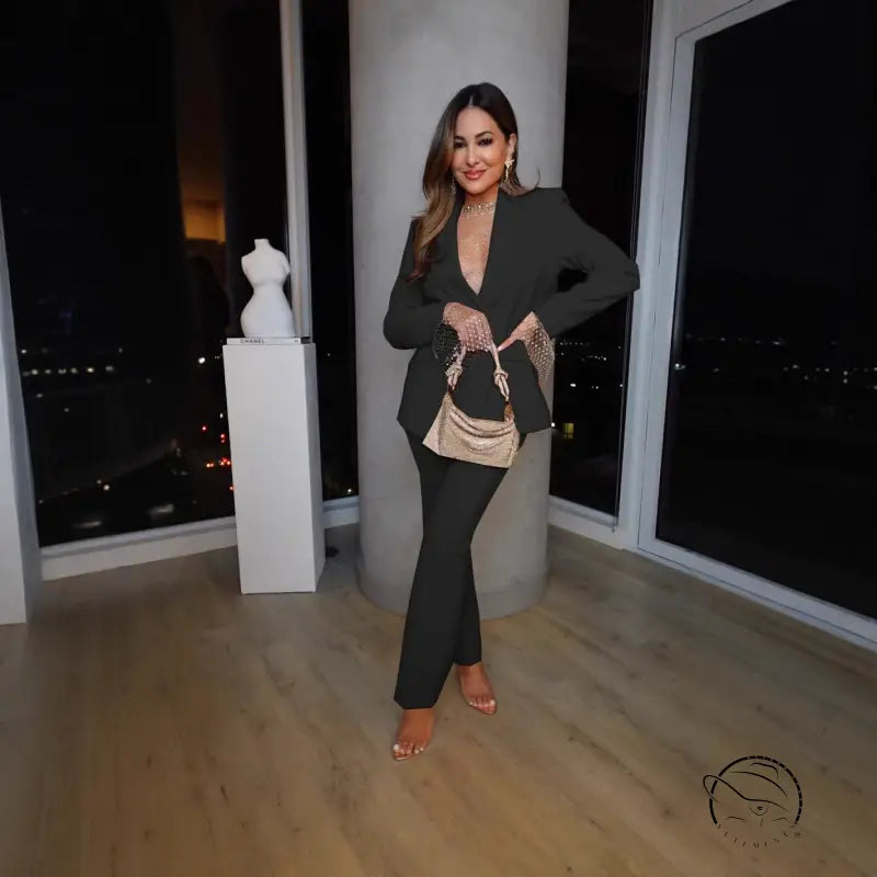 Woman in black pantsuit with gold purse in casual professional pants two piece set