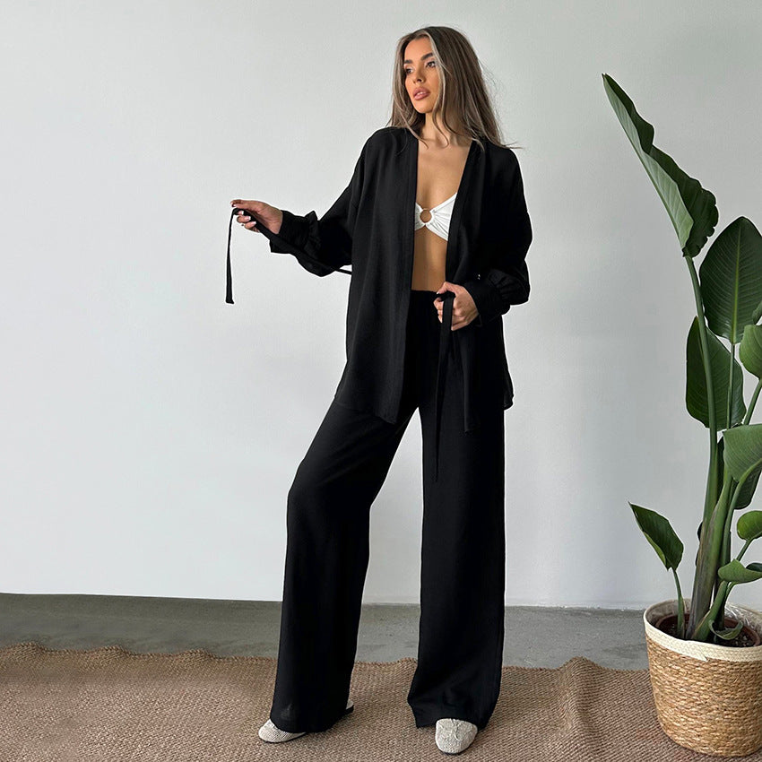 Woman wearing comfy cotton linen pajamas with a black two-piece set and white bikini top