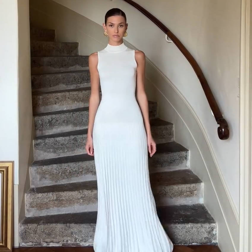 Sleeveless white maxi dress with pleated skirt detailing for elegant fashion style