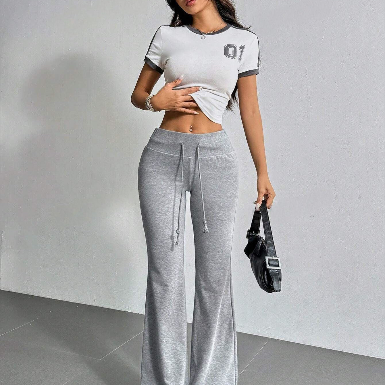 Woman in sporty outfit featuring High Waist Casual Solid Color Bell Bottom Pants for fashion