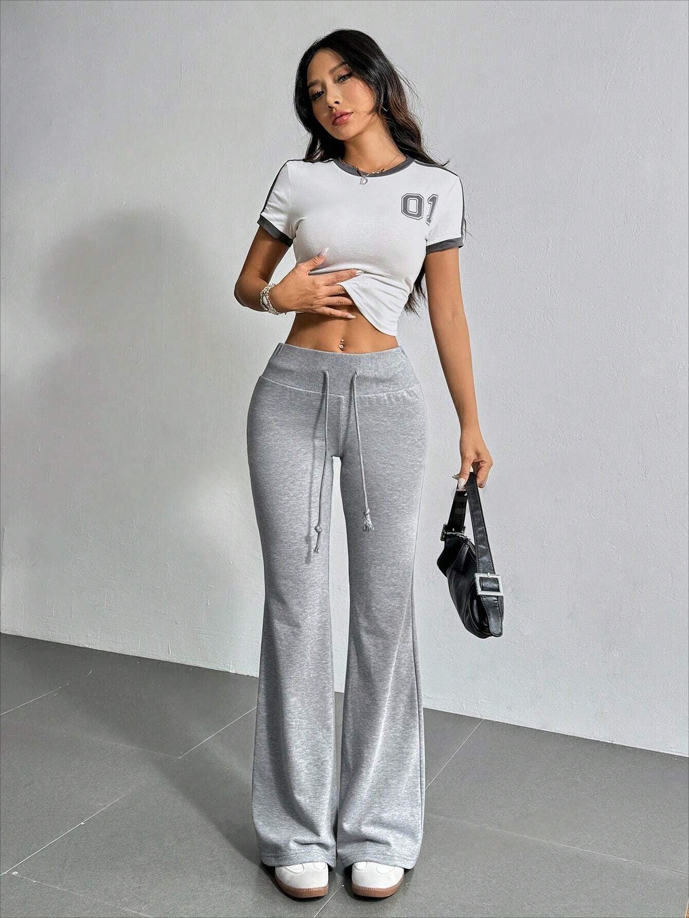 Woman in sporty outfit featuring High Waist Casual Solid Color Bell Bottom Pants for fashion