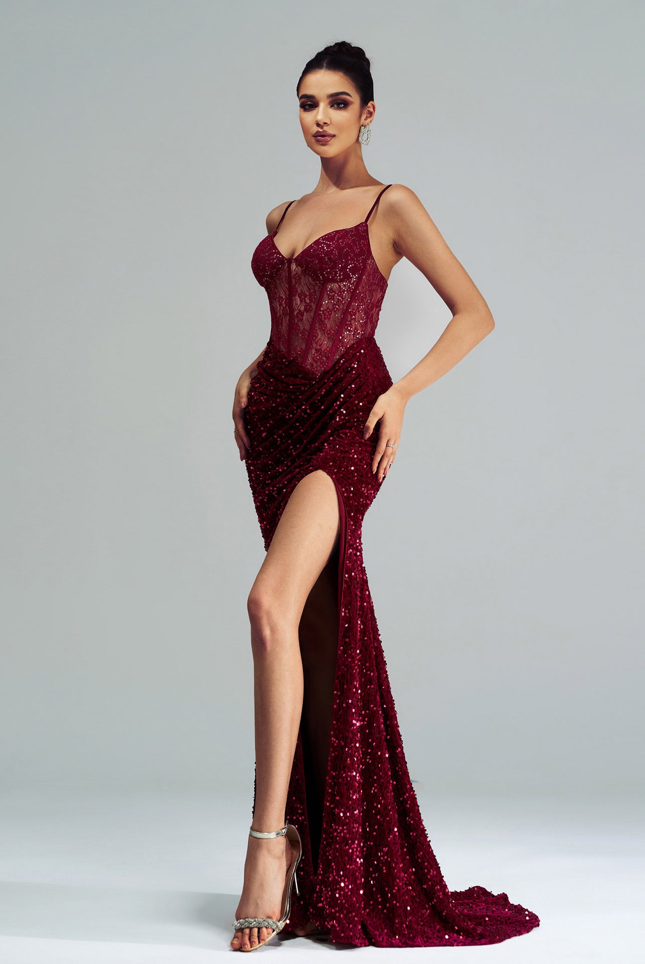 Burgundy sequined evening gown with high slit, perfect for langry fashion events
