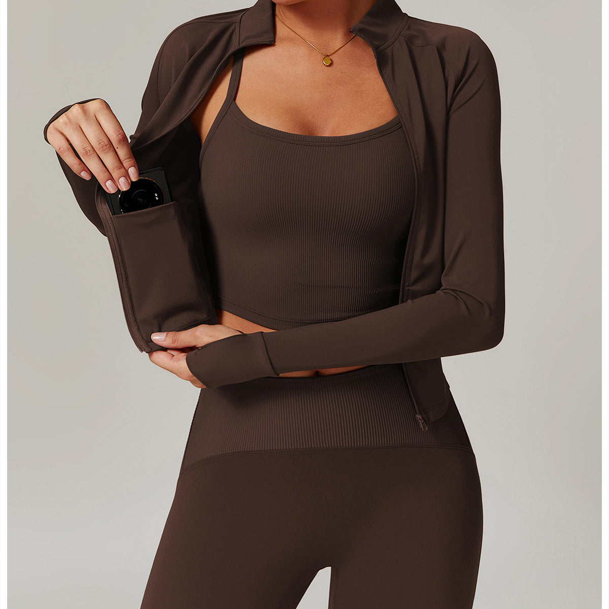 Brown athletic workout set featuring cropped tank top, sheer cover-up, and fitted leggings