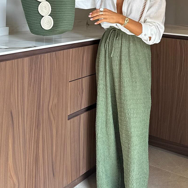 Casual white collared shirt with green embroidery and wide-leg green pants in langry fashion