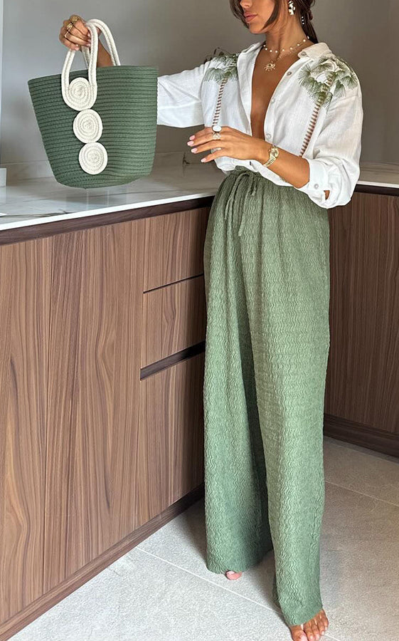 Casual white collared shirt with green embroidery and wide-leg green pants in langry fashion