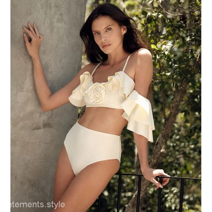 Woman in a cream-colored elegant retro swimsuit showcasing vintage style and sophistication
