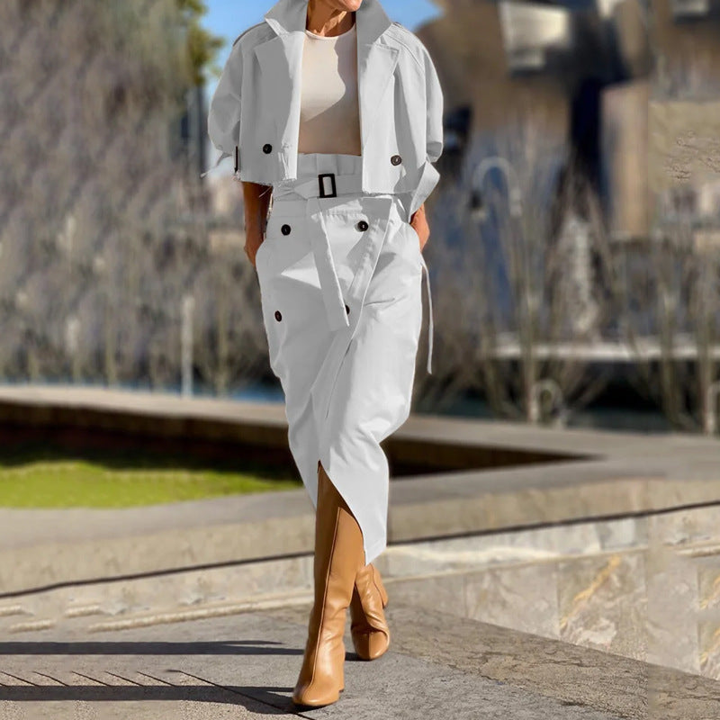 Elegant woman in white belted trench coat and tan boots showcasing langry fashion with ملابس