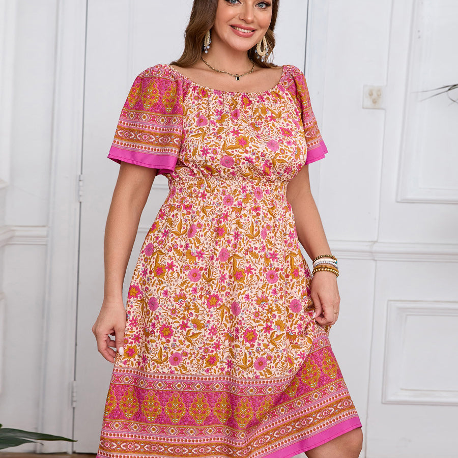 Elegant bohemian dress with floral pattern and vibrant pink-orange border print