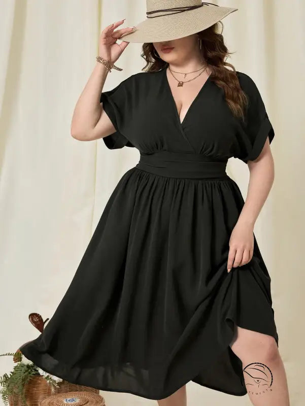 Plus-size woman in vacation high waist A-line black V-neck midi dress and hat