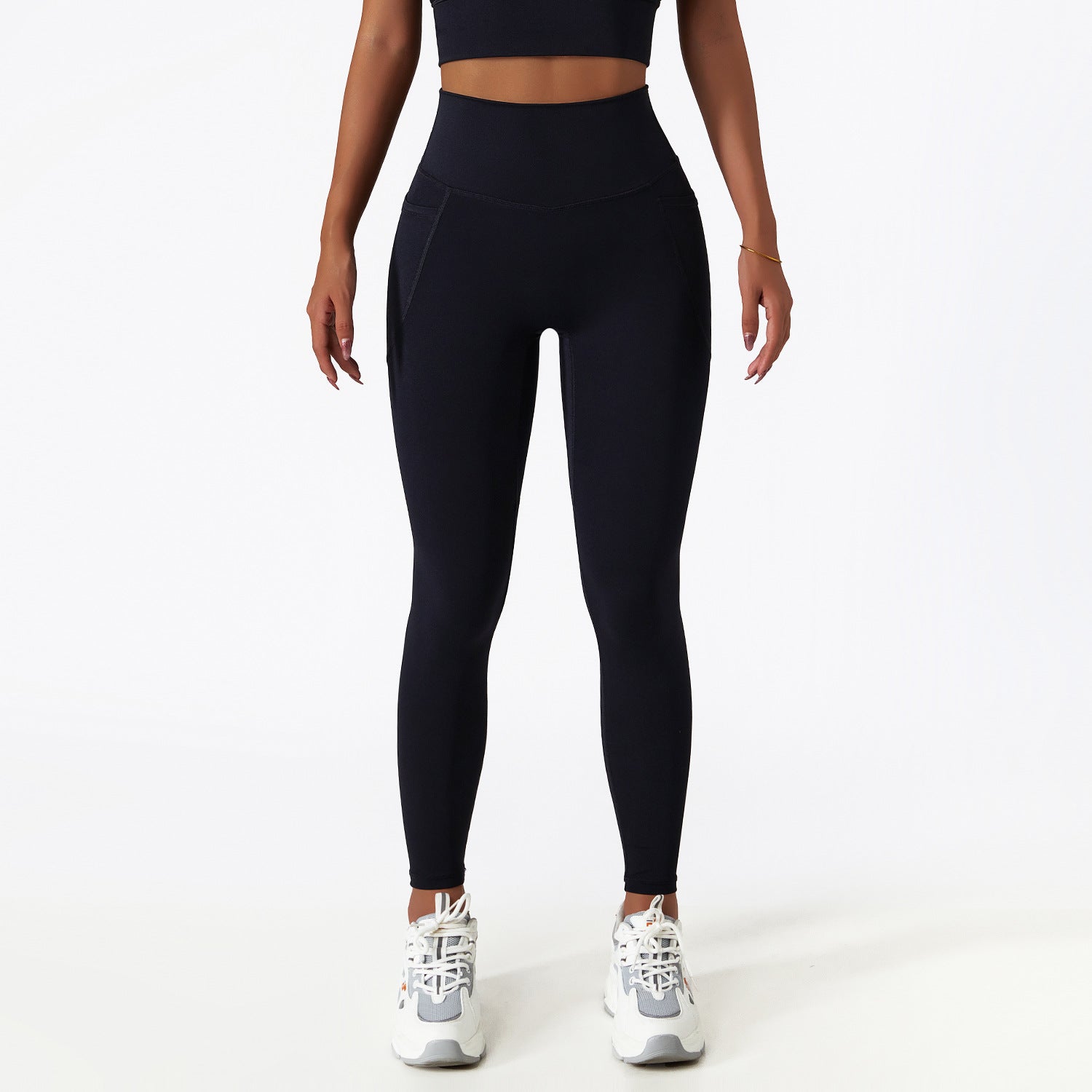 Black high-waisted athletic leggings paired with white sneakers for stylish yoga fashion