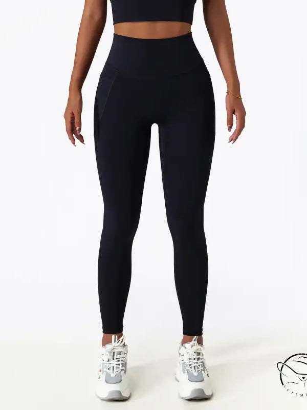 Black high-waisted yoga pants with white sneakers for langry fashion