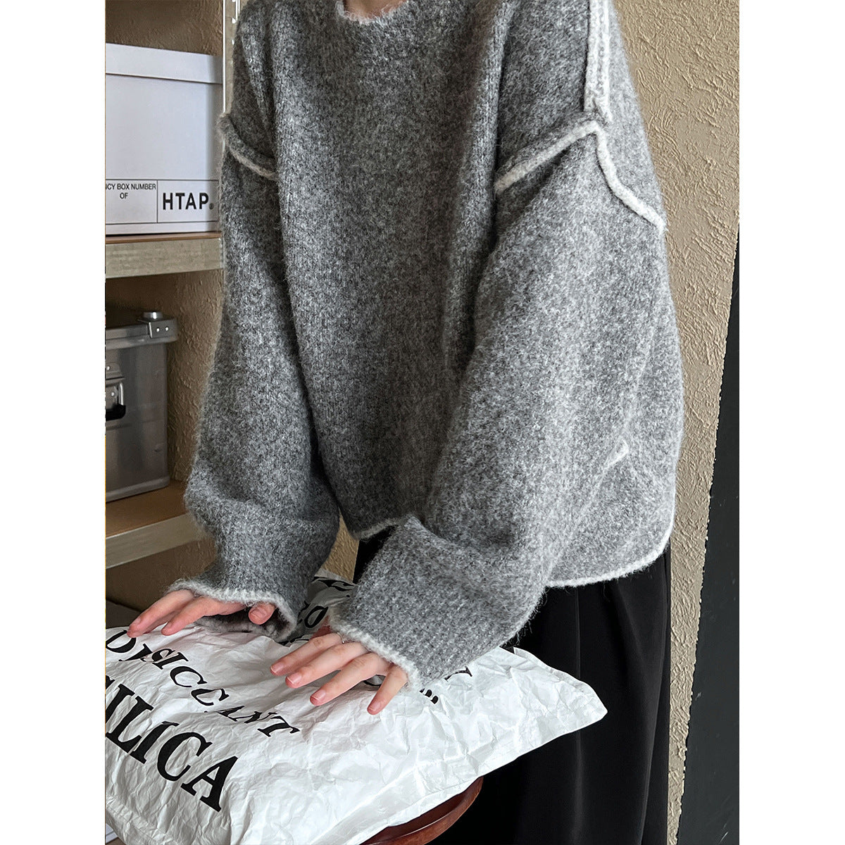 Cozy grey knit sweater with oversized sleeves for casual fashion and comfort