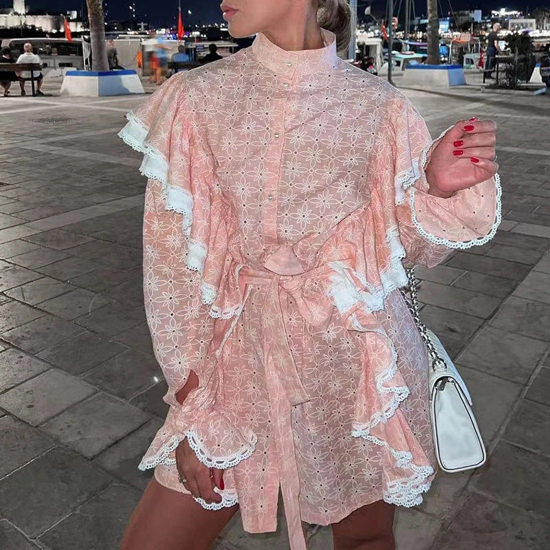 Pink eyelet dress with ruffles featuring a stand collar and fashionable bell sleeves