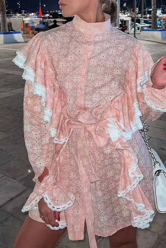 Pink eyelet dress with ruffles and stand collar showcasing elegant summer fashion