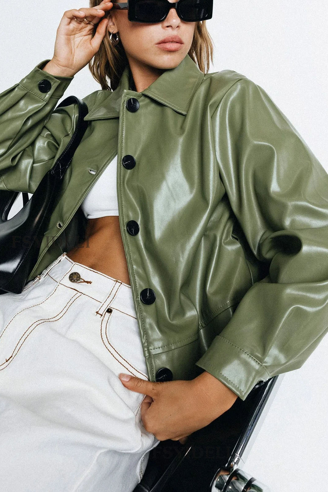 Langry faux leather jacket in olive green with black buttons and white cropped jeans