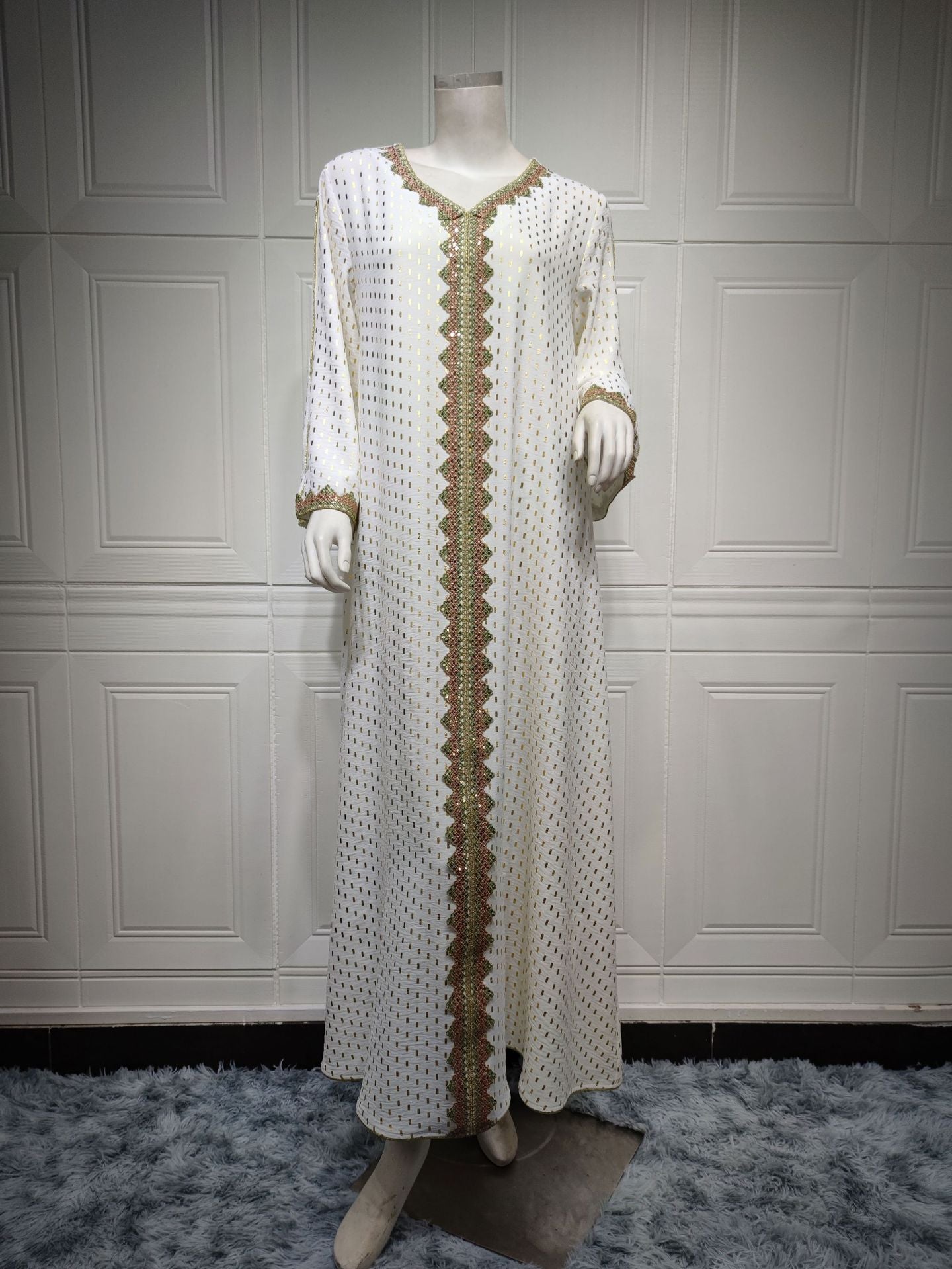 Elegant white and gold embroidered langry fashion dress on mannequin