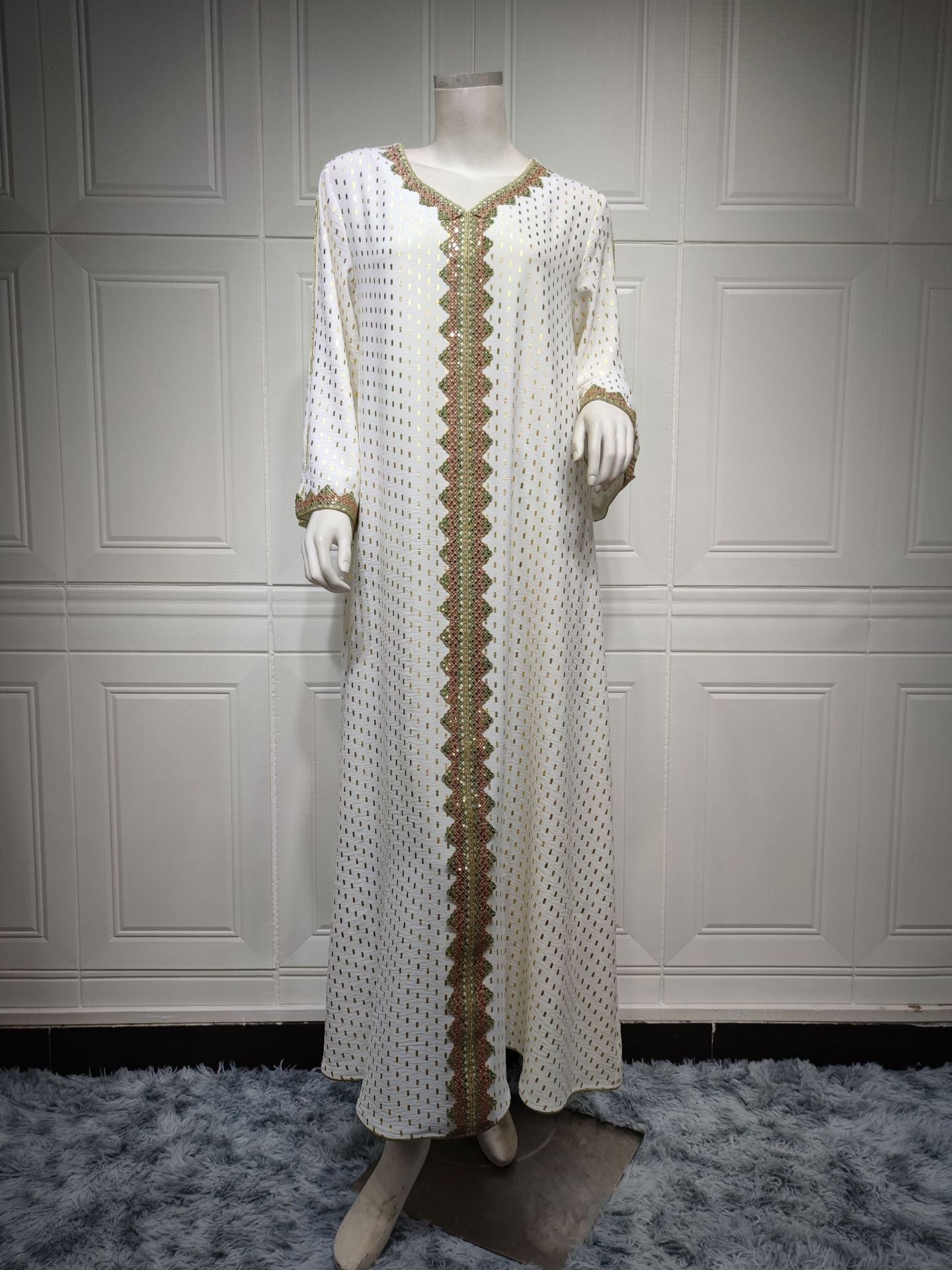 Elegant white and gold embroidered langry fashion dress on mannequin