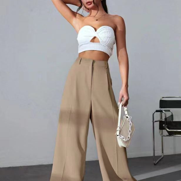Wide leg khaki pants with white cropped bustier and sneakers for a trendy fashion look