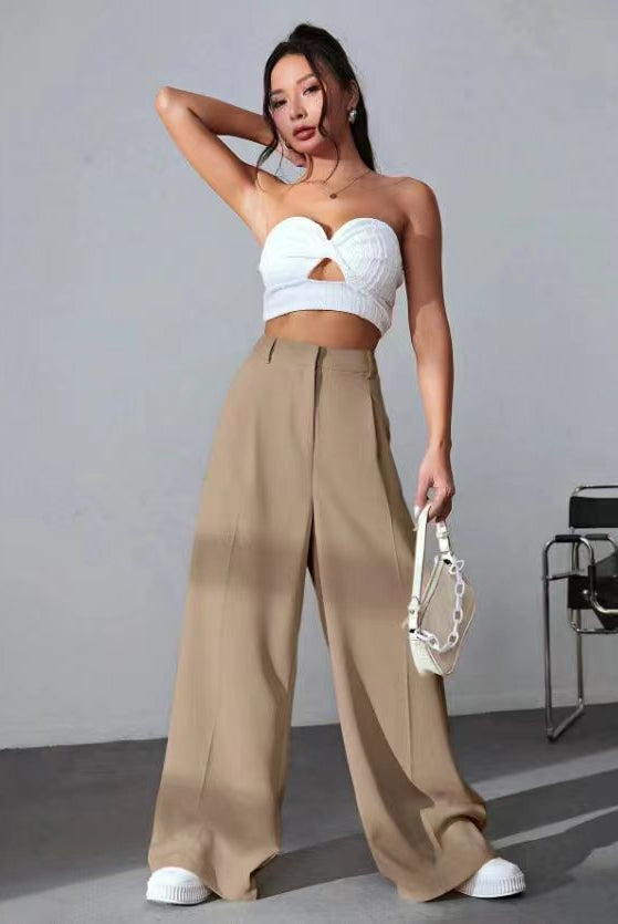 Wide leg khaki pants with white cropped bustier and sneakers for a trendy fashion look