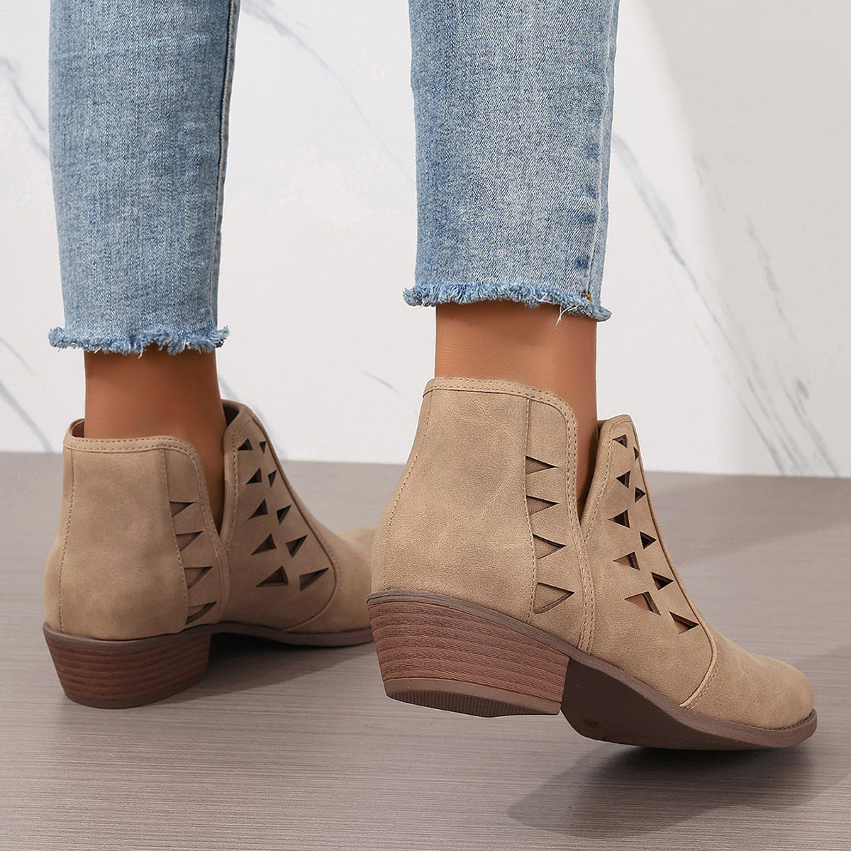 Beige suede daily ankle boots featuring triangular cutouts and stacked wooden heels