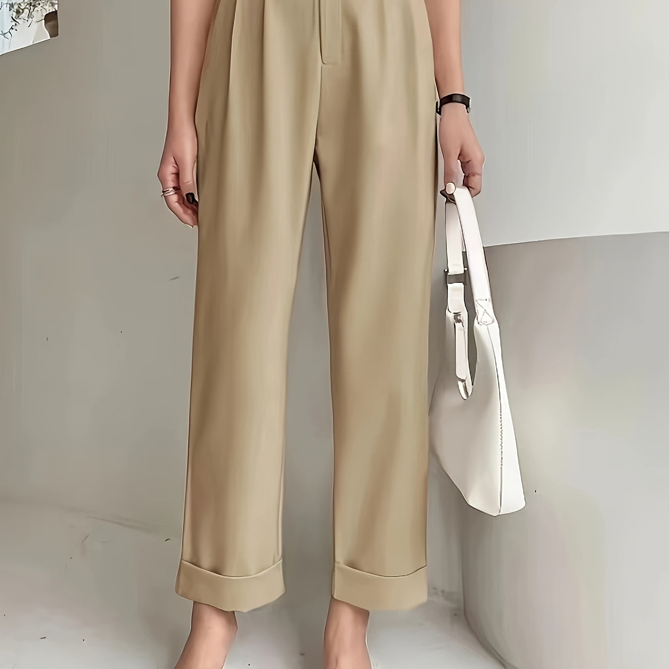 Beige wide leg pant with cuffed hems paired with white pointed flats for a stylish look