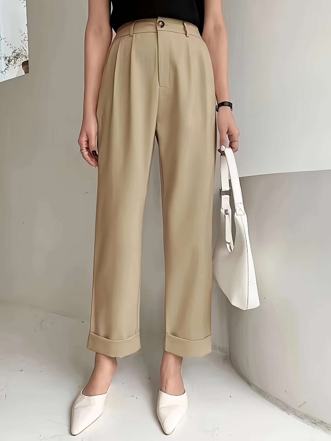Beige wide leg pant with cuffed hems paired with white pointed flats for a stylish look