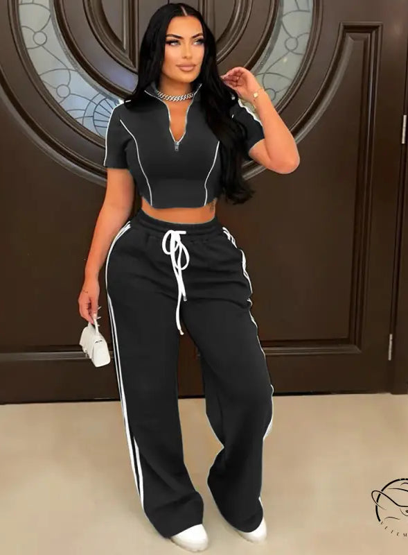 Black and white loose trousers with side stripes and drawstring waist