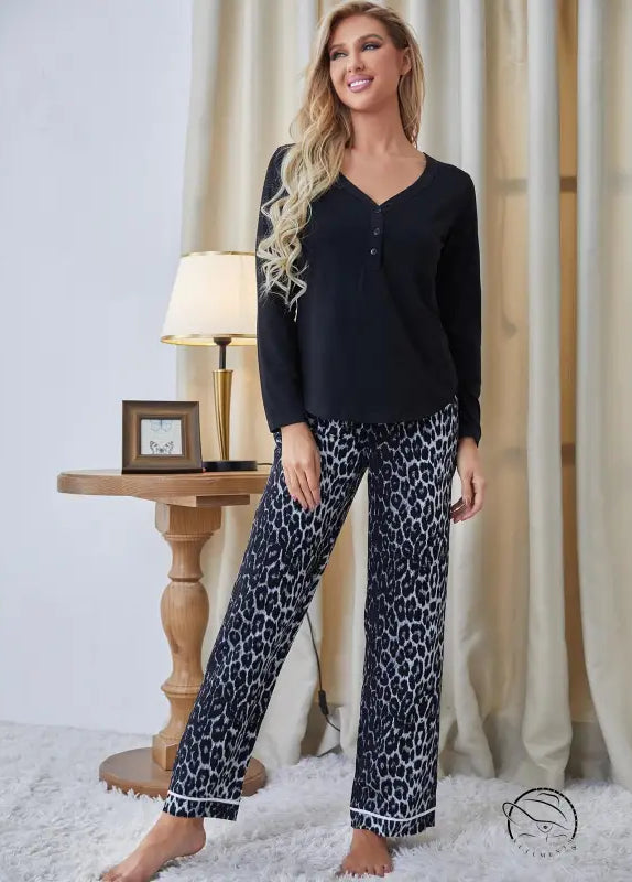 Black long-sleeved langry pajama top with leopard-print pants and white piping