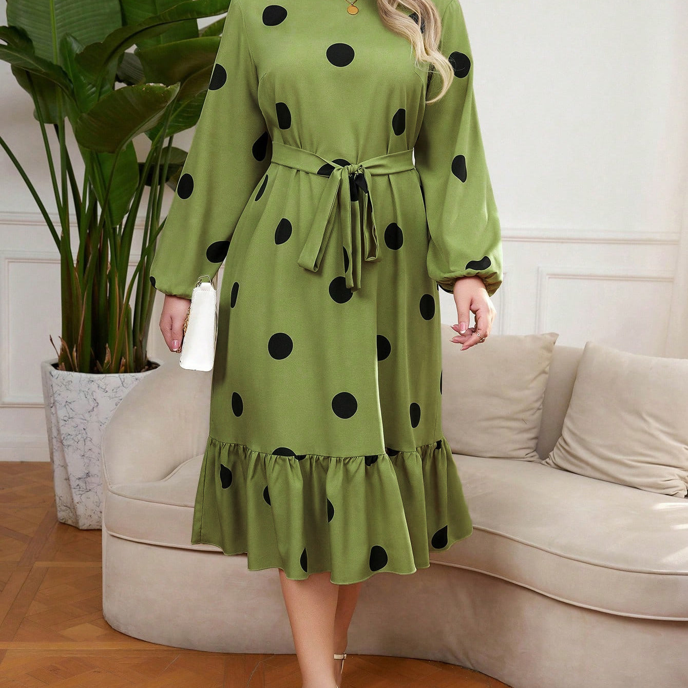 Green midi Lotus Leaf Dress with black polka dots and ruffled hem for elegant style