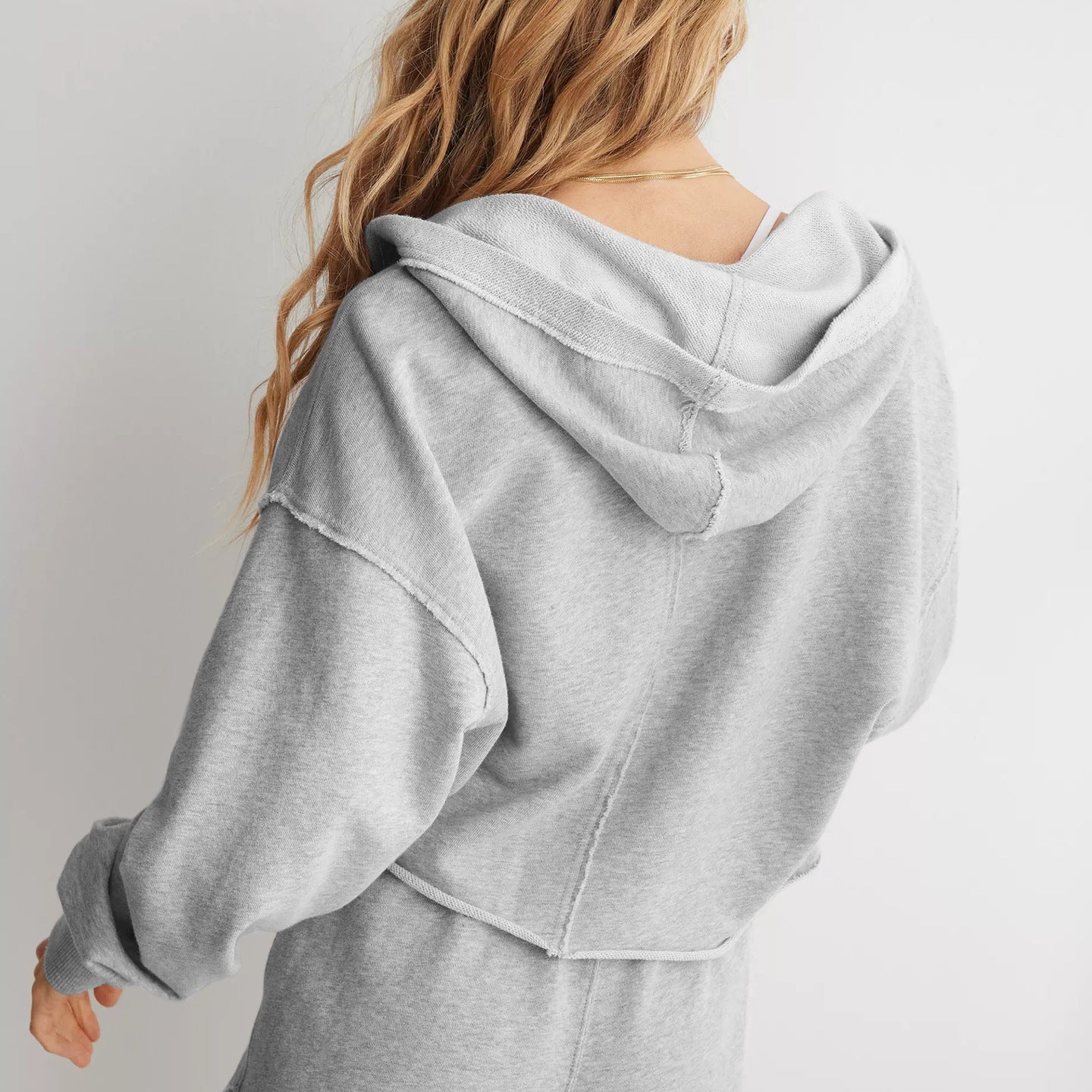 Light gray Cozy Loose Hooded Sweatshirt on a person with blonde hair, showcasing fashion ملابس