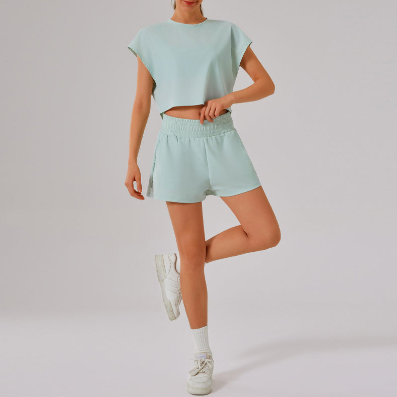 Mint green Loose Sports Yoga Fitness Set with matching crop top, shorts, and white sneakers