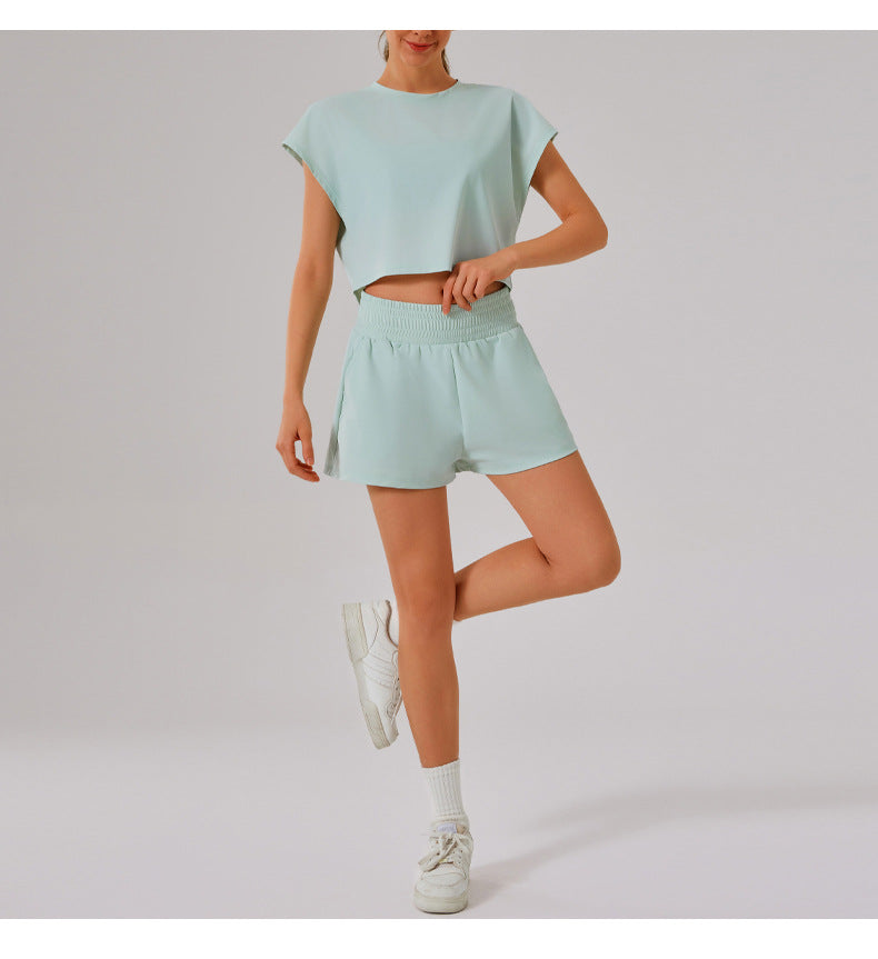 Mint green Loose Sports Yoga Fitness Set with matching crop top, shorts, and white sneakers
