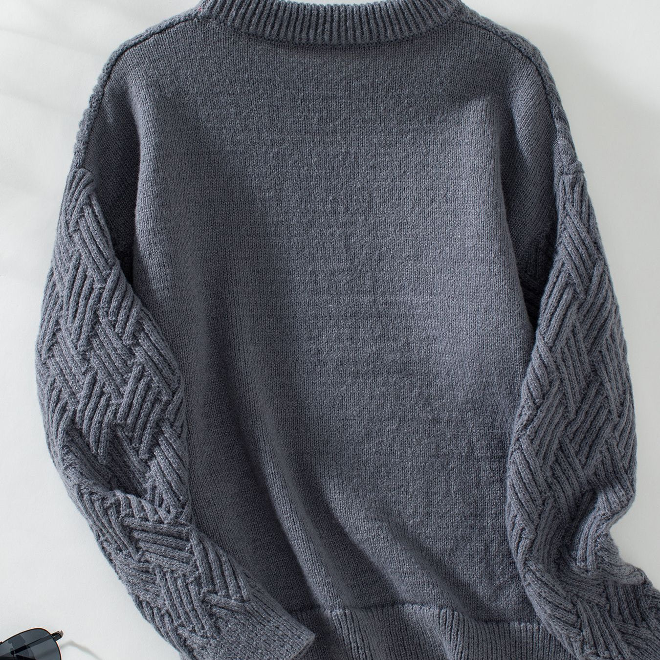 Charcoal gray crew neck cable knit sweater with textured sleeves