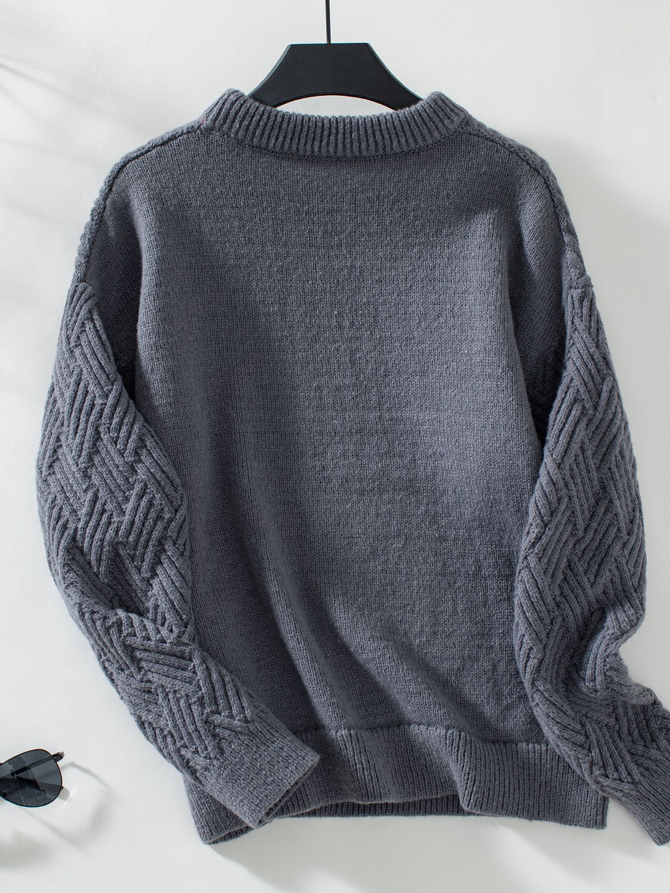 Charcoal gray crew neck cable knit sweater with textured sleeves