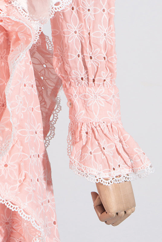Pink eyelet dress with ruffled trim, stand collar, and bell sleeves for elegant fashion