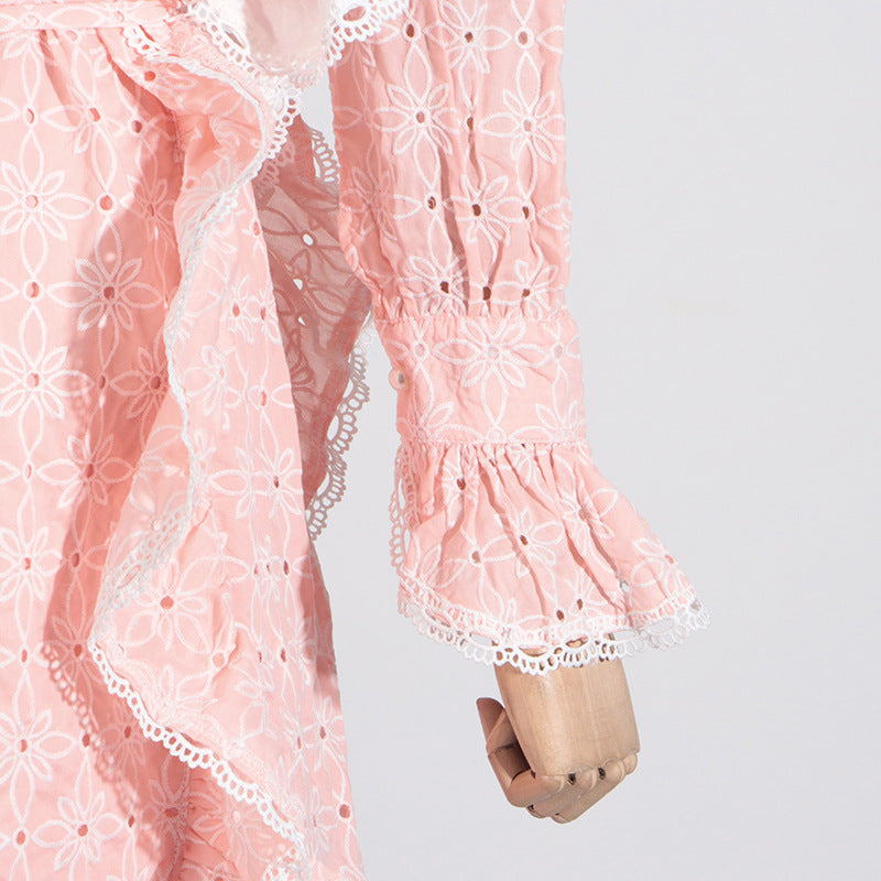 Pink eyelet dress with ruffled trim, stand collar, and bell sleeves for elegant fashion