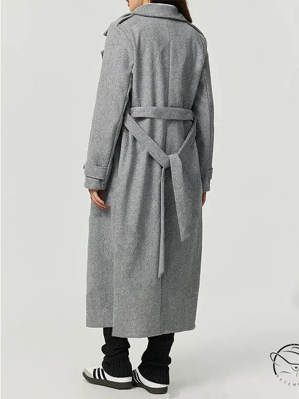 Long gray wool trench coat with double-breasted buttons and belt, cozy woolen fashion outerwear