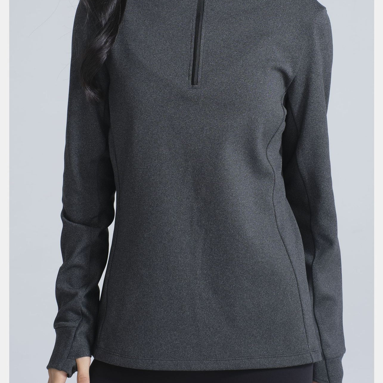 Dark gray long-sleeved athletic top with quarter-zip collar and thumbholes for winter thermal fashion