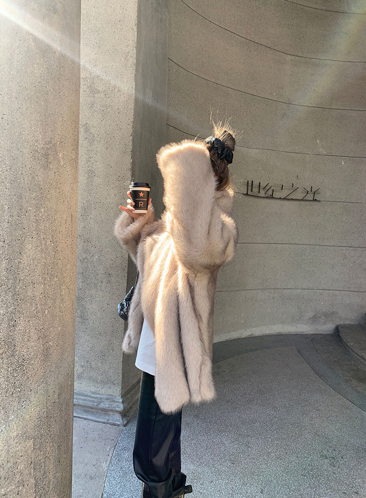 Cream-colored faux fur Langry hooded shearling jacket with black leather boots