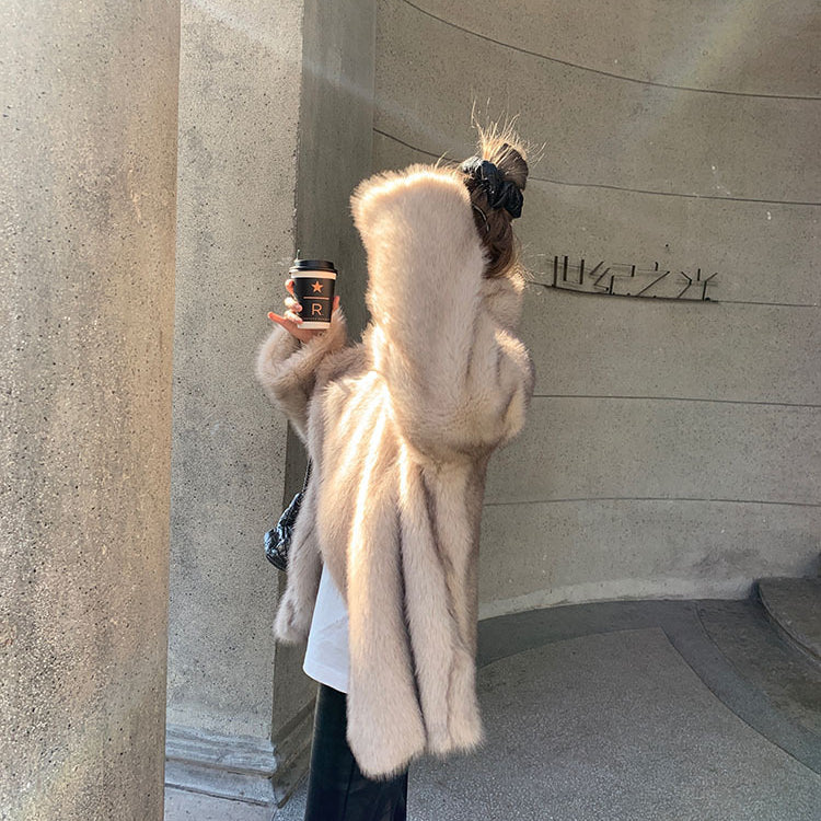 Cream-colored faux fur Langry hooded shearling jacket with black leather boots