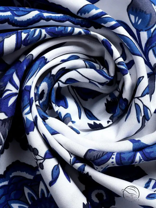 Folded blue white maxi dress fabric with floral pattern