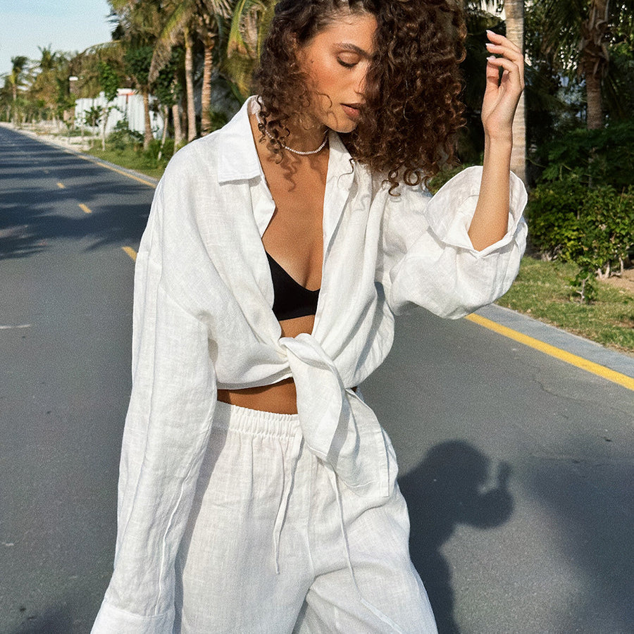 Woman in white linen outfit showcasing Cotton Shirt Trousers Casual Sets for fashion lovers