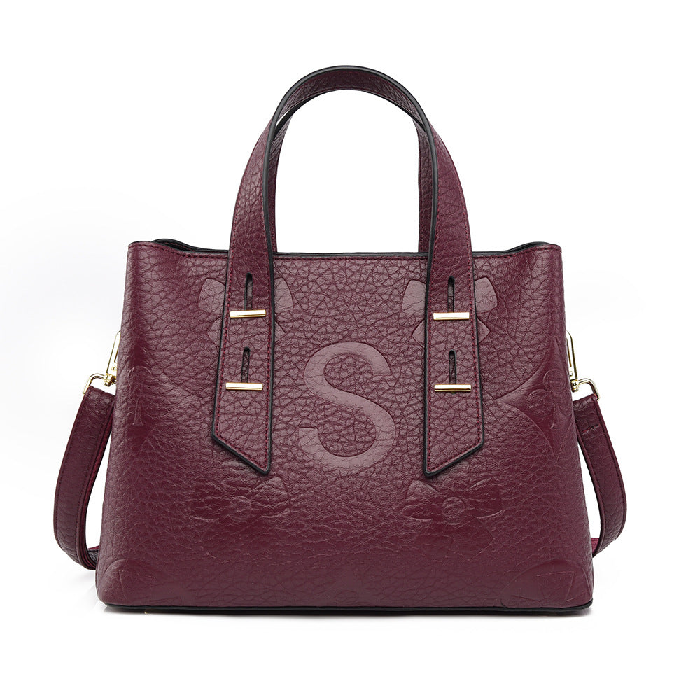 Langry fashion burgundy leather tote with gold hardware and S monogram