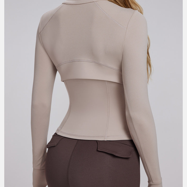 Woman wearing beige cropped jacket and brown leggings in Slim Fit Breathable Yoga Jacket for fashion and ملابس